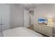 Bedroom with neutral walls and a television on top of a light colored dresser at 8045 Tybee Ct # 8045, University Park, FL 34201