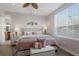 Comfortable bedroom featuring a ceiling fan, large window with blinds, and stylish decor at 8045 Tybee Ct # 8045, University Park, FL 34201