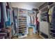 Walk-in closet featuring built-in shelving and organization, providing ample storage space at 8045 Tybee Ct # 8045, University Park, FL 34201