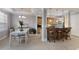 Cozy dining area with white table, chairs, and bar seating in the kitchen, great for Gathering meals at 8045 Tybee Ct # 8045, University Park, FL 34201