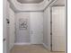 Hallway view featuring multiple doors, neutral paint, and tiled floors, providing access to various rooms at 8045 Tybee Ct # 8045, University Park, FL 34201