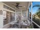 Relaxing lanai featuring comfortable seating, ceiling fan, and water view at 8045 Tybee Ct # 8045, University Park, FL 34201