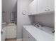 Functional laundry room with a washing machine, dryer, sink, and plenty of storage space at 8045 Tybee Ct # 8045, University Park, FL 34201