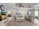 Bright living room featuring neutral paint, ceiling fans, and a sliding glass door leading to the lanai at 8045 Tybee Ct # 8045, University Park, FL 34201