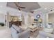 Inviting living room with two ceiling fans, kitchen view, and comfortable seating area for relaxing or entertaining at 8045 Tybee Ct # 8045, University Park, FL 34201