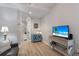 Cozy living room with hardwood floors, a comfortable couch, and a mounted television at 8045 Tybee Ct # 8045, University Park, FL 34201