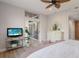 Bright main bedroom featuring a ceiling fan, sliding glass door access to lanai, and a light-colored color scheme at 8045 Tybee Ct # 8045, University Park, FL 34201
