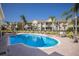 Inviting community pool with ample lounge chairs and well-maintained landscaping at 8045 Tybee Ct # 8045, University Park, FL 34201