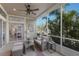 Relaxing sunroom features comfortable seating, ceiling fan, and serene views of lush tropical greenery at 8045 Tybee Ct # 8045, University Park, FL 34201