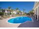 Sparkling pool surrounded by lounge chairs, palm trees, and well-maintained landscaping at 8045 Tybee Ct # 8045, University Park, FL 34201