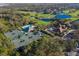 Elevated view showcasing the community tennis and pool club with golf course and clubhouse in the background at 8771 52Nd E Ave, Bradenton, FL 34211