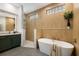 Bathroom boasts wood look ceramic tile, glass enclosed shower, and a luxurious soaking tub at 8771 52Nd E Ave, Bradenton, FL 34211