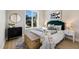 Bright bedroom with a stylish green headboard, modern decor, and a window view at 8771 52Nd E Ave, Bradenton, FL 34211