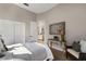 Comfortable bedroom featuring a side table desk, modern decor, and ample closet space at 8771 52Nd E Ave, Bradenton, FL 34211