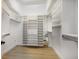 Walk-in closet with custom built-in shelving offering ample storage space at 8771 52Nd E Ave, Bradenton, FL 34211