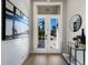 Stylish foyer with a double-door entrance, sleek console table, and decorative accents at 8771 52Nd E Ave, Bradenton, FL 34211