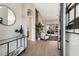 Inviting foyer featuring wood flooring, modern decor, and a view into the living area at 8771 52Nd E Ave, Bradenton, FL 34211