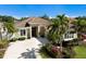Beautiful home with a well-manicured lawn, mature palms, and inviting driveway at 8771 52Nd E Ave, Bradenton, FL 34211