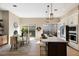 Bright kitchen with stainless steel appliances, a large center island with seating, and sliding glass doors at 8771 52Nd E Ave, Bradenton, FL 34211