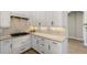 Modern kitchen featuring white cabinets, countertops, and stylish hardware at 8771 52Nd E Ave, Bradenton, FL 34211