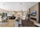 Open-concept living area with wood floors, white cabinets, and a fireplace feature wall at 8771 52Nd E Ave, Bradenton, FL 34211