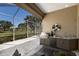 Screened outdoor kitchen features a stainless steel grill, sink, granite countertops and views of the golf course at 8771 52Nd E Ave, Bradenton, FL 34211