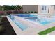 A modern backyard pool with cascading waterfall feature, and lush landscaping at 8771 52Nd E Ave, Bradenton, FL 34211