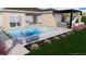 A backyard pool with spa and patio featuring an outdoor kitchen area at 8771 52Nd E Ave, Bradenton, FL 34211
