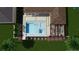 Aerial view of a backyard pool and patio area with a pergola and lush landscaping at 8771 52Nd E Ave, Bradenton, FL 34211