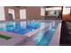 A modern backyard pool with spa and waterfall feature, and stylish patio furniture at 8771 52Nd E Ave, Bradenton, FL 34211