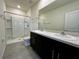 This bathroom features double sinks, black cabinets, and a walk-in shower at 8864 Milestone Dr, Sarasota, FL 34238