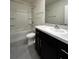 This bathroom offers a shower-tub combo and black cabinets with a sink at 8864 Milestone Dr, Sarasota, FL 34238