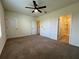 Bedroom with carpet flooring, ceiling fan, and doors to closet and bathroom at 8864 Milestone Dr, Sarasota, FL 34238