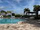 Relax poolside with beautiful landscaping and sunny skies at community pool at 8864 Milestone Dr, Sarasota, FL 34238