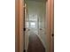 This hallway features carpeted floors and neutral walls at 8864 Milestone Dr, Sarasota, FL 34238