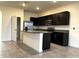 Kitchen featuring dark cabinets, stainless steel appliances, a pantry, and a center island at 8864 Milestone Dr, Sarasota, FL 34238