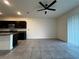 Open concept kitchen with dark cabinets, granite countertops, stainless steel appliances, and tile flooring at 8864 Milestone Dr, Sarasota, FL 34238