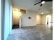 Open-concept living room with tile flooring, stairs, and lots of light at 8864 Milestone Dr, Sarasota, FL 34238