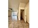 Open-concept living area with sliding glass doors, tile floors, and a ceiling fan at 8864 Milestone Dr, Sarasota, FL 34238
