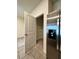 Walk-in pantry next to a stainless steel refrigerator with shelving at 8864 Milestone Dr, Sarasota, FL 34238