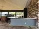 Outdoor kitchen area at community pool features bar, counter, and stone wall at 8864 Milestone Dr, Sarasota, FL 34238