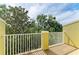 A sunny outdoor balcony that overlooks lush green trees and features a white railing at 8943 White Sage Loop, Lakewood Ranch, FL 34202