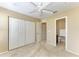 Bedroom with a ceiling fan, large closet, access to an ensuite bathroom and plush carpet at 8943 White Sage Loop, Lakewood Ranch, FL 34202