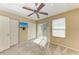 Bedroom with a ceiling fan, plush carpet, large windows and a sliding glass door to a balcony at 8943 White Sage Loop, Lakewood Ranch, FL 34202