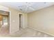 Bedroom with plush carpet, ceiling fan, access to a bathroom and balcony for a relaxing vibe at 8943 White Sage Loop, Lakewood Ranch, FL 34202