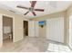 Bright bedroom featuring a ceiling fan, TV, large closet, and easy access to an ensuite bathroom at 8943 White Sage Loop, Lakewood Ranch, FL 34202