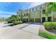 Inviting two-story townhomes with attached garages, well-maintained landscaping, and ample parking on a sunny day at 8943 White Sage Loop, Lakewood Ranch, FL 34202