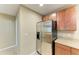 Modern kitchen area showcasing stainless steel refrigerator and ample cabinetry for storage at 8943 White Sage Loop, Lakewood Ranch, FL 34202