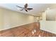 Expansive living room with laminate floors, neutral walls, and a modern ceiling fan at 8943 White Sage Loop, Lakewood Ranch, FL 34202