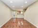 Open-concept living area features wood laminate flooring, neutral paint, and seamless flow to the kitchen at 8943 White Sage Loop, Lakewood Ranch, FL 34202